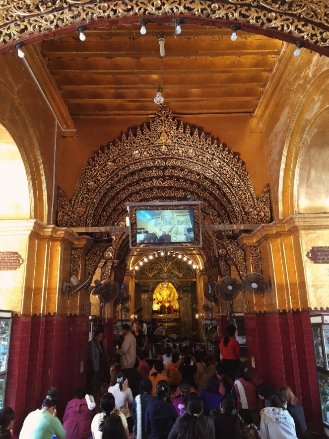 Mahamuni Temple. Inside is the image - it's gold plated.